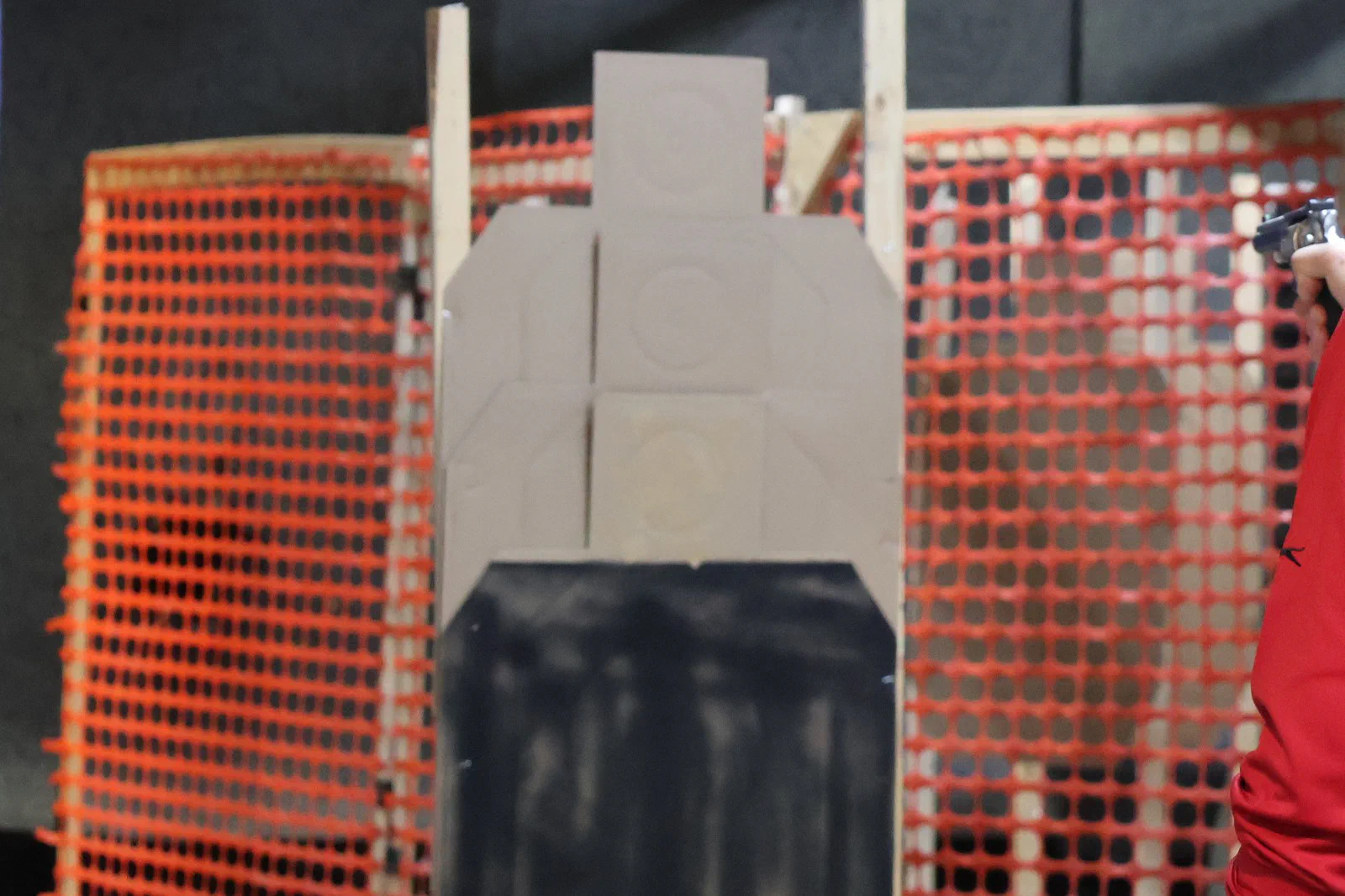 A cardboard target partly hidden behind a black-painted panel